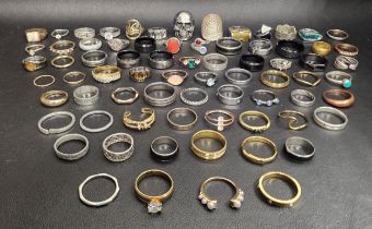 SELECTION OF SILVER AND OTHER RINGS including a large skull decorated ring, CZ and stone set