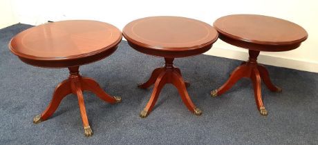 THREE MAHOGANY AND CROSSBANDED OCCASIONAL TABLES with circular tops on a turned columns with four