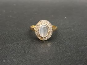 MOONSTONE AND DIAMOND CLUSTER RING the central oval cabochon moonstone approximately 8mm x 5mm, in