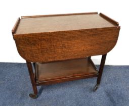 1950s OAK TEA TROLLEY with a rectangular top with shaped drop flaps, the undertier with a removeable