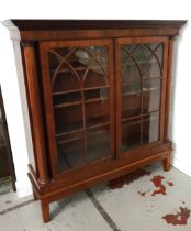 EARLY 20th CENTURY MAHOGANY BOOKCASE with a stepped moulded top above a pair of glass panel doors