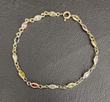 EIGHTEEN CARAT GOLD BRACLET set with faceted coloured glass, 19cm long and total weight