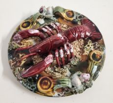 PORTUGUESE PALISSY MAJOLICA WALL PLATE decorated with a lobster on the sea bed among coral, 19cm