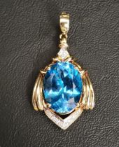 IMPRESSIVE BLUE TOPAZ AND DIAMOND PENDANT the large oval cut topaz measuring 20.3mm x 15mm x 9.5mm