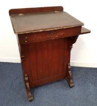 THE BENNETT FURNISHING COMPANY OAK CLERKS DESK with a raised back above a central pen trough flanked