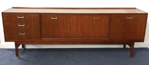 1960s TEAK SIDEBOARD with a raised back and rectangular top above two pairs of central folding