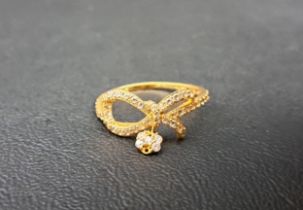CZ SET TWENTY-ONE CARAT GOLD RING of bow design with cluster drop, ring size P-Q and approximately