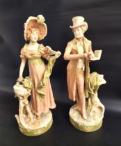 PAIR OF ROYAL DUX FIGURINES depicting a gentleman in top hat and tail coat holding a book, and a