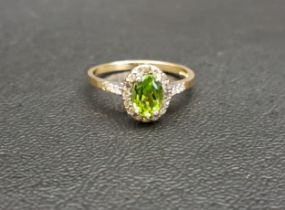 PERIDOT AND DIAMOND CLUSTER RING the central oval cut peridot approximately 0.75cts in sixteen