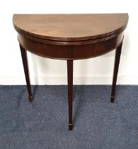 MAHOGANY DEMI LUNE OCCASIONAL TABLE with a fold over top, standing on tapering supports with spade