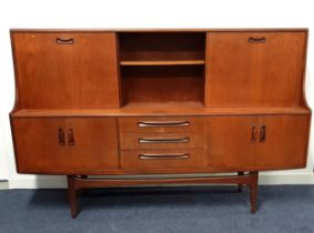 G PLAN TEAK SIDE CABINET the upper section with a sliding cupboard door, a central open shelf and