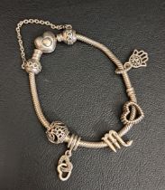 PANDORA HEART CLASP MOMENTS SNAKE CHAIN SILVER CHARM BRACELET with five silver Pandora charms and