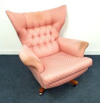 1950s WING BACK ARMCHAIR with a button back on a rotating base with casters