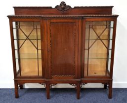 MAHOGANY BREAKFRONT DISPLAY CABINET with a carved and shaped raised mirror back above a central