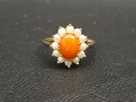 CORAL AND PEARL CLUSTER DRESS RING the central oval coral cabochon in twelve pearl surround, on nine