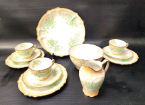 EARLY 20th CENTURY TEA SET with a white ground decorated with floral sprays and gilt highlights,