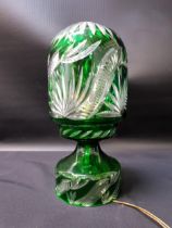 EDWARDIAN EMERALD GLASS TABLE LAMP raised on a circular base with a domed top, 30.5cm high