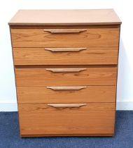 TEAK EFFECT CHEST OF DRAWERS with five graduated drawers, standing on a plinth base with casters,