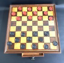 TABLE TOP MAHOGANY DRAUGHTS/CHESS BOARD with a frieze drawer containing draughts