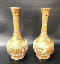 PAIR OF JAPANESE SATSUMA BOTTLE VASES decorated with figural and floral panels, 24cm high (2)