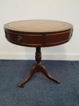 MAHOGANY DRUM TOP OCCASIONAL TABLE with a tooled leather inset top above two frieze drawers,