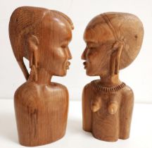 TWO AFRICAN CARVED BUSTS depicting a tribal man and woman, 28cm high (2)
