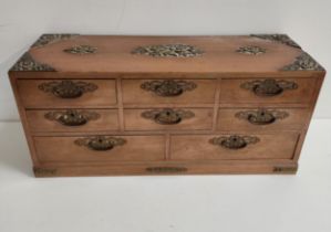 CHINESE TABLE TOP TEAK COLLECTORS CABINET with brass floral decoration and corner mounts, with