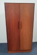 G PLAN TEAK WARDROBE with two doors opening to reveal a hanging rail, shelves and drawers,