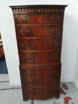 MAHOGANY BOW FRONT CHEST ON CHEST with seven cockbeaded and graduated drawers and a brushing