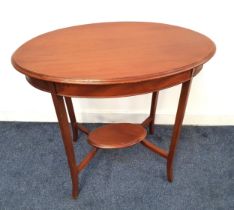 EDWARDIAN MAHOGANY OCCASIONAL TABLE with an oval moulded top, standing on shaped supports united