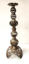 ORNATE BRASS PILLAR CANDLE STICK with pierced decoration, raised on a shaped tri-form base, 71cm