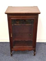 EDWARDIAN MAHOGANY MUSIC CABINET with a panelled glass door opening to reveal a shaped shelved