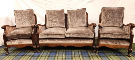 EARLY 20th CENTURY OAK BERGERE SUITE comprising a two seat sofa and two armchairs with shaped