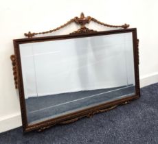 RECTANGULAR WALL MIRROR with a textured wood frame surmounted with an urn and garlands, with a