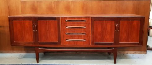 G PLAN TEAK SIDEBOARD with four central drawers flanked by two pairs of panelled cupboard doors,