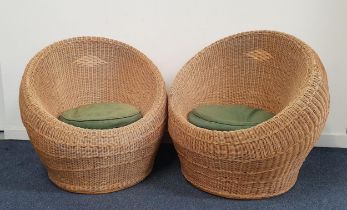 PAIR OF RATTAN BALL ARMCHAIRS with shaped rounded bodies and loose seat cushions (2)