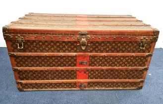 VINTAGE LOUIS VUITTON LARGE MONOGRAM STEAMER TRUNK with wood banding and metal fixtures, the brass