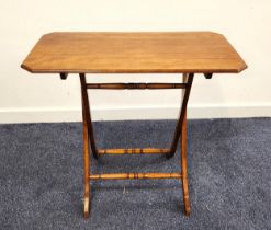 MAHOGANY COACHING TABLE with a rectangular top with canted corners on a folding X frame with
