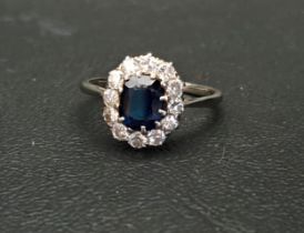 SAPPHIRE AND DIAMOND CLUSTER RING the oval cut sapphire approximately 1ct in twelve diamond surround