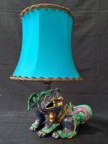 CHINESE STYLE POTTERY FOO DOG TABLE LAMP the blue body with gilt highlights and a green and mauve