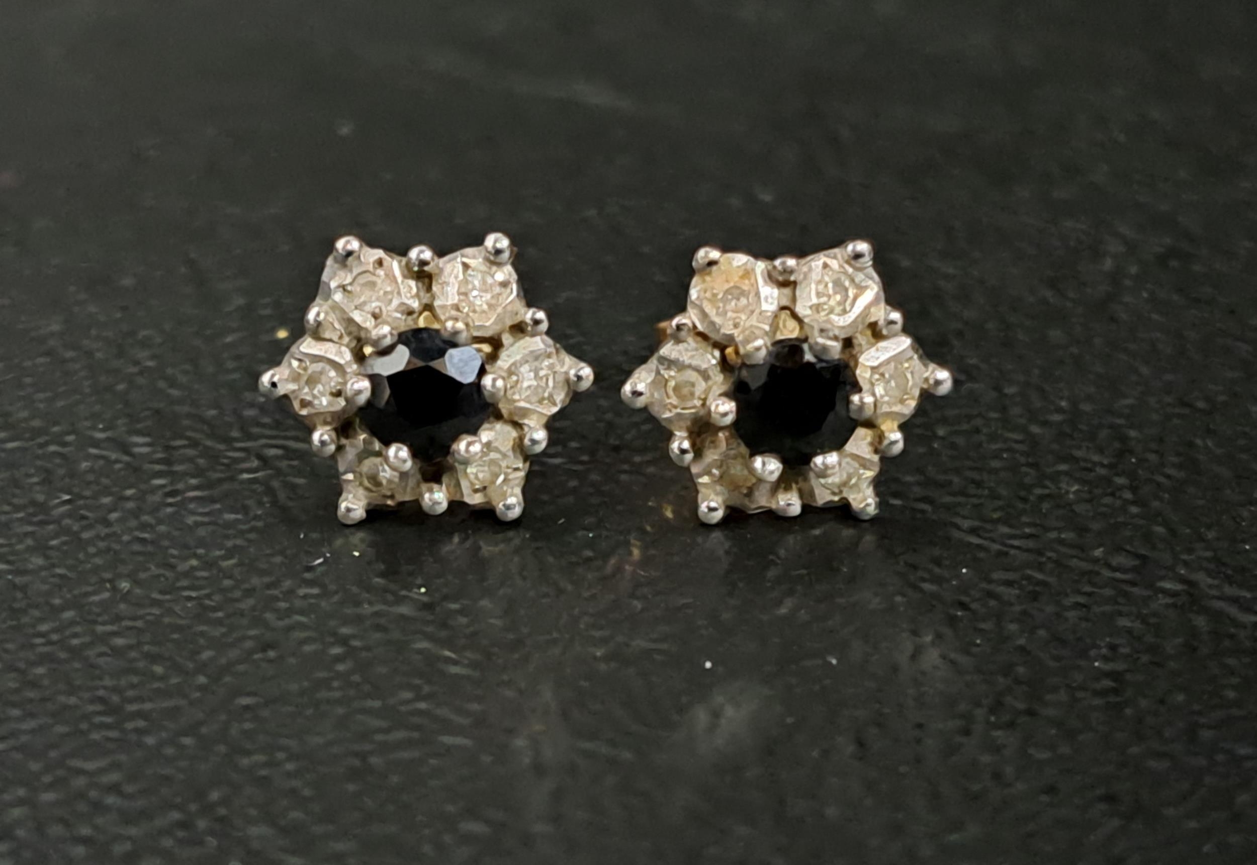 PAIR OF SAPPHIRE AND DIAMOND CLUSTER EARRINGS the central sapphire on each in six diamond
