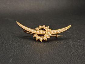 VICTORIAN/EDWARDIAN SEED PEARL SET BROOCH in the form of a crescent moon and stylised sun, in