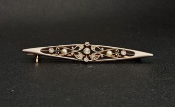 EDWARDIAN DIAMOND AND SEED PEARL BROOCH of pierced navette form, the diamonds totalling