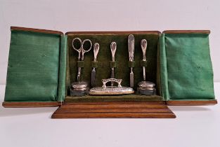 GEORGE V SILVER MANICURE SET comprising a buffer, two files, tweezers, cuticle pusher and two silver