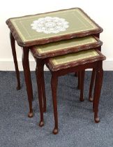 MAHOGANY NEST OF TABLES with inset green leather glass covered tops, standing on cabriole
