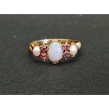 VICTORIAN OPAL, RUBY AND SEED PEARL RING the central opal measuring 6mm x 5mm, in unmarked high