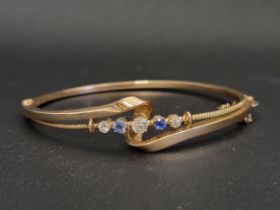 EARLY 20th CENTURY DIAMOND AND SAPPHIRE SET BANGLE the five graduated gemstones in attractive