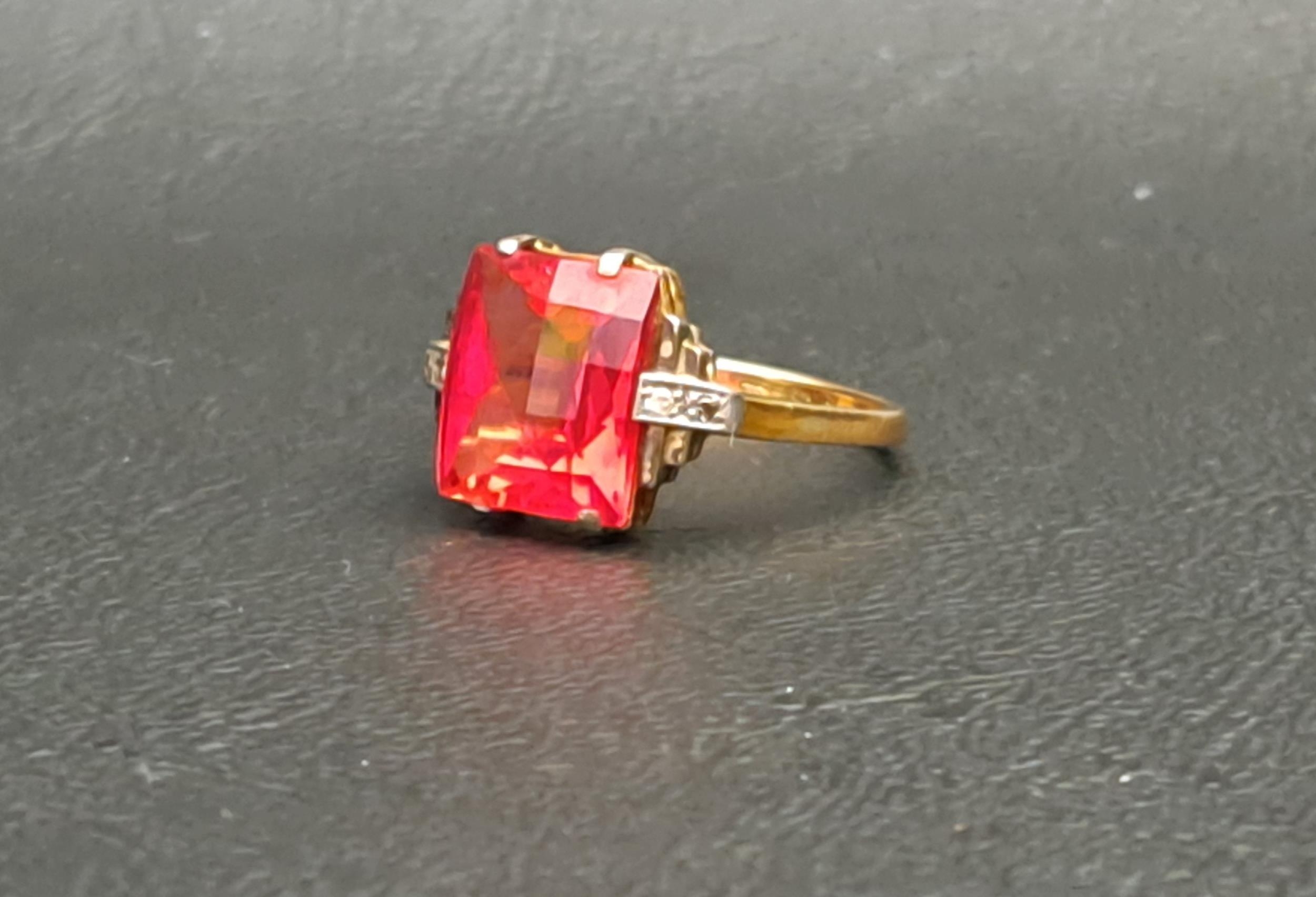 RED GEM AND DIAMOND SET RING the central checkerboard cut gemstone possibly ruby and measuring - Image 2 of 3