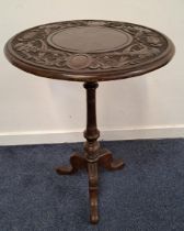 VICTORIAN CARVED OAK OCCASIONAL TABLE with a circular top decorated with bird heads, on a turned