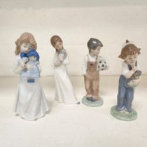 FOUR NAO FIGUREINES all depicting children, two holding dolls, another a football and the last a